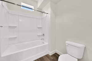Bathroom featuring a white tub with integrated shelving, chrome fixtures, and a shower curtain rod