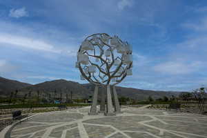 Sculptural tree-inspired art installation featuring white cube elements