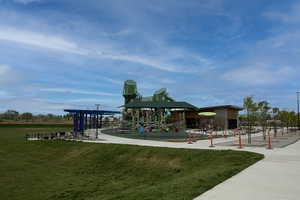 Expansive recreation area featuring a modern playground, sheltered picnic spaces, and mature landscaping