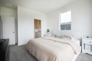 Bedroom featuring a single window, carpeted flooring, and a two-panel interior door