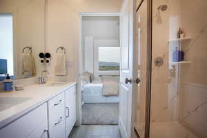 Bathroom featuring a dual vanity with light-toned countertops and undermount sinks