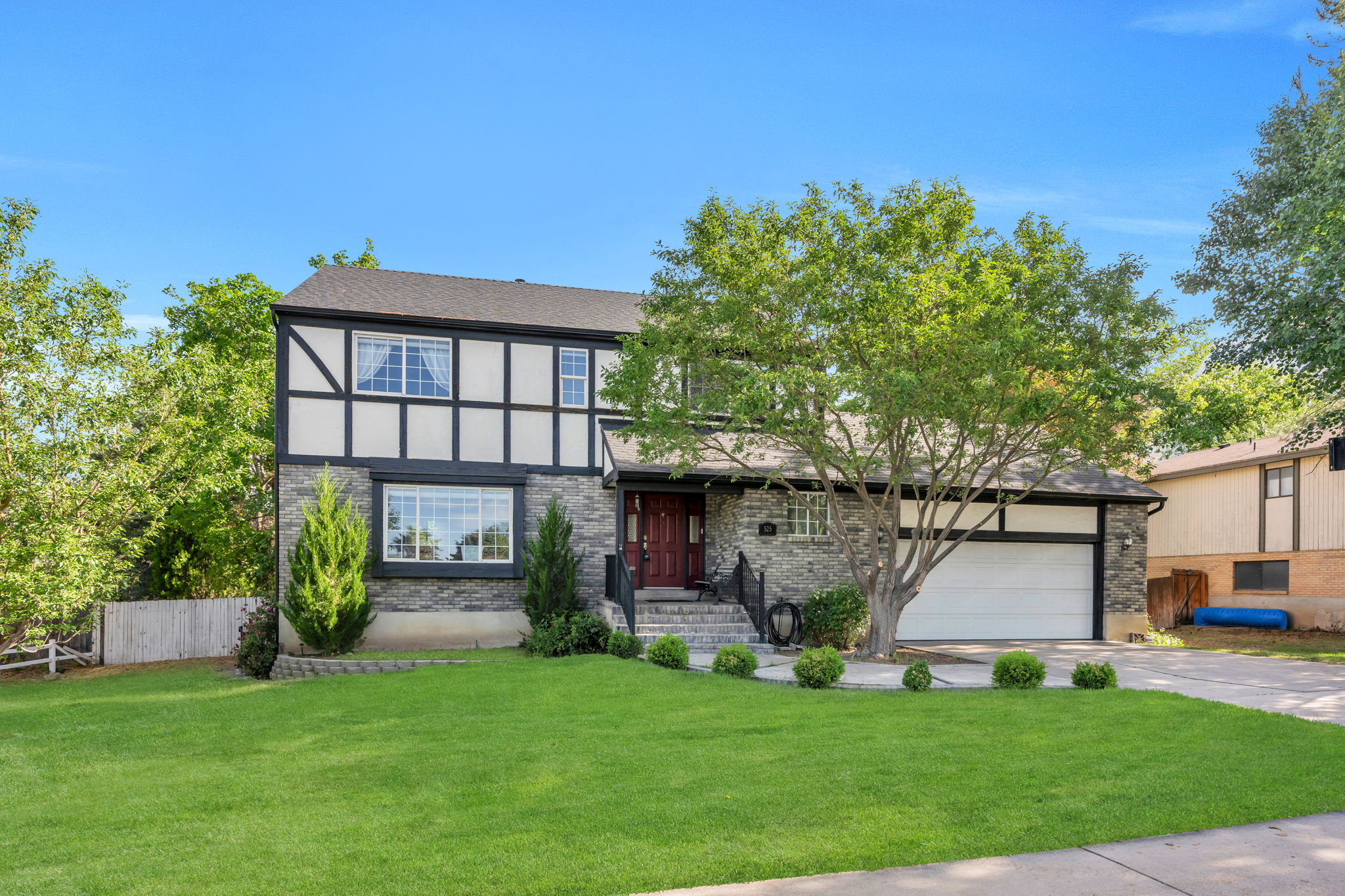 Tudor-style exterior featuring stone and stucco finishes