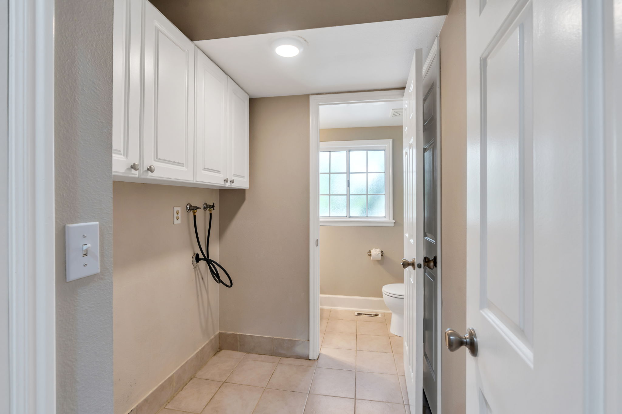 Main floor laundry room with storage