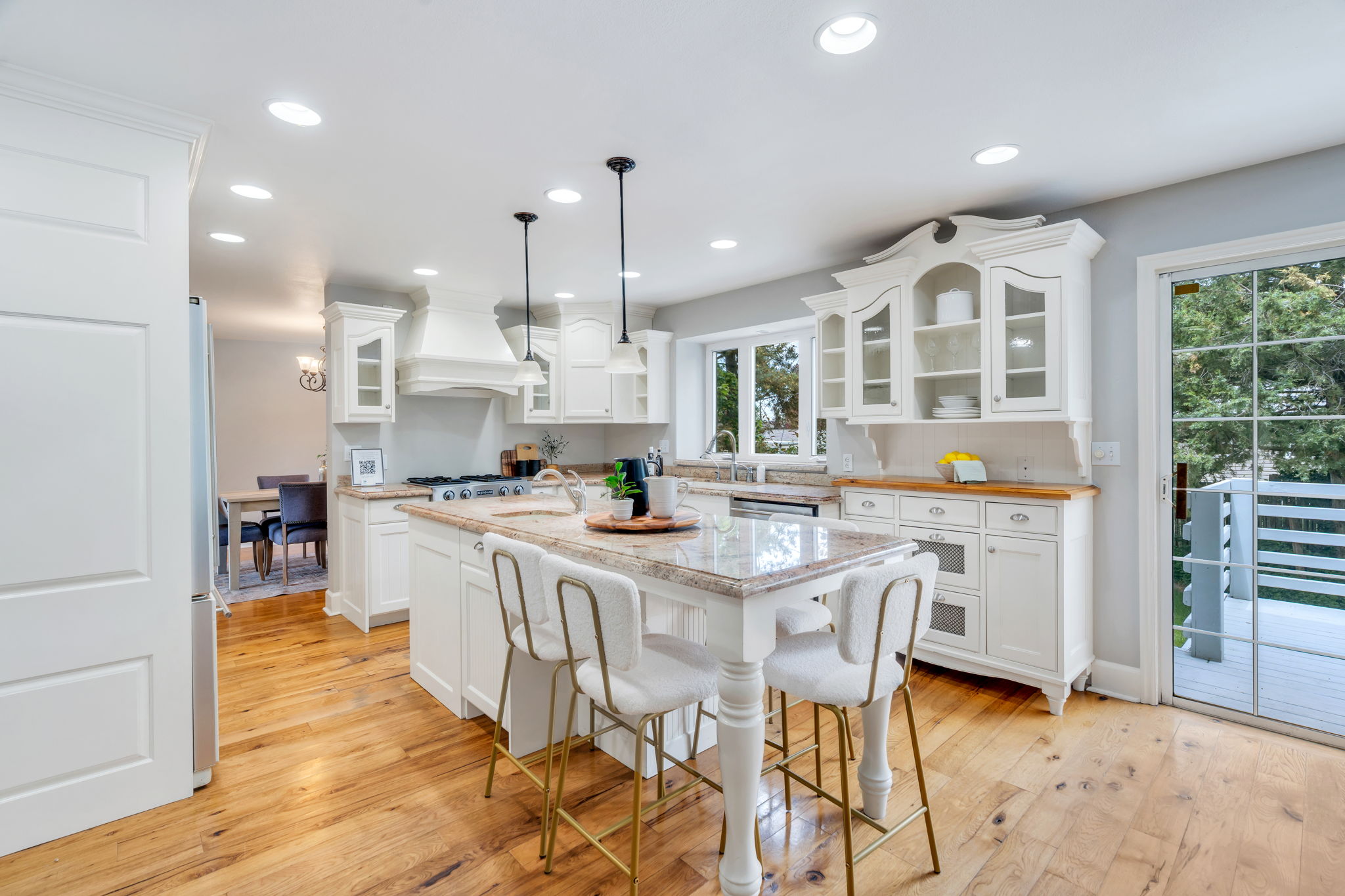Bright kitchen with a central island featuring a stone countertop