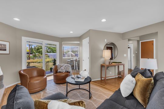 Living area featuring light wood-finish flooring, recessed lighting, and neutral wall tones
