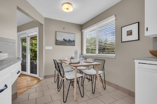 Dining area featuring tile flooring, a large window with blinds, and recessed lighting