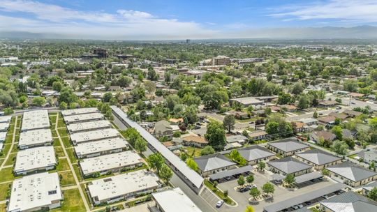 Aerial perspective showcasing multiple residential buildings and surrounding green spaces
