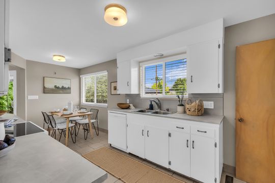Kitchen with white cabinetry and light gray countertops