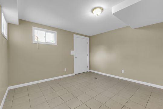 Room featuring neutral-toned walls, tile flooring, and a flush mount ceiling light