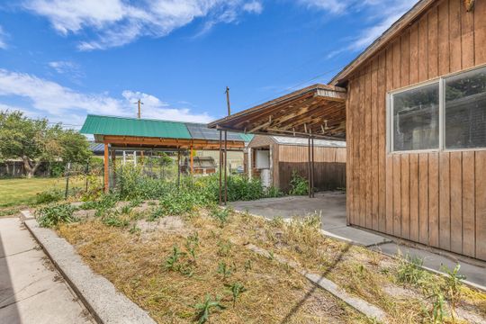 Wood-sided exterior structure with a covered concrete patio