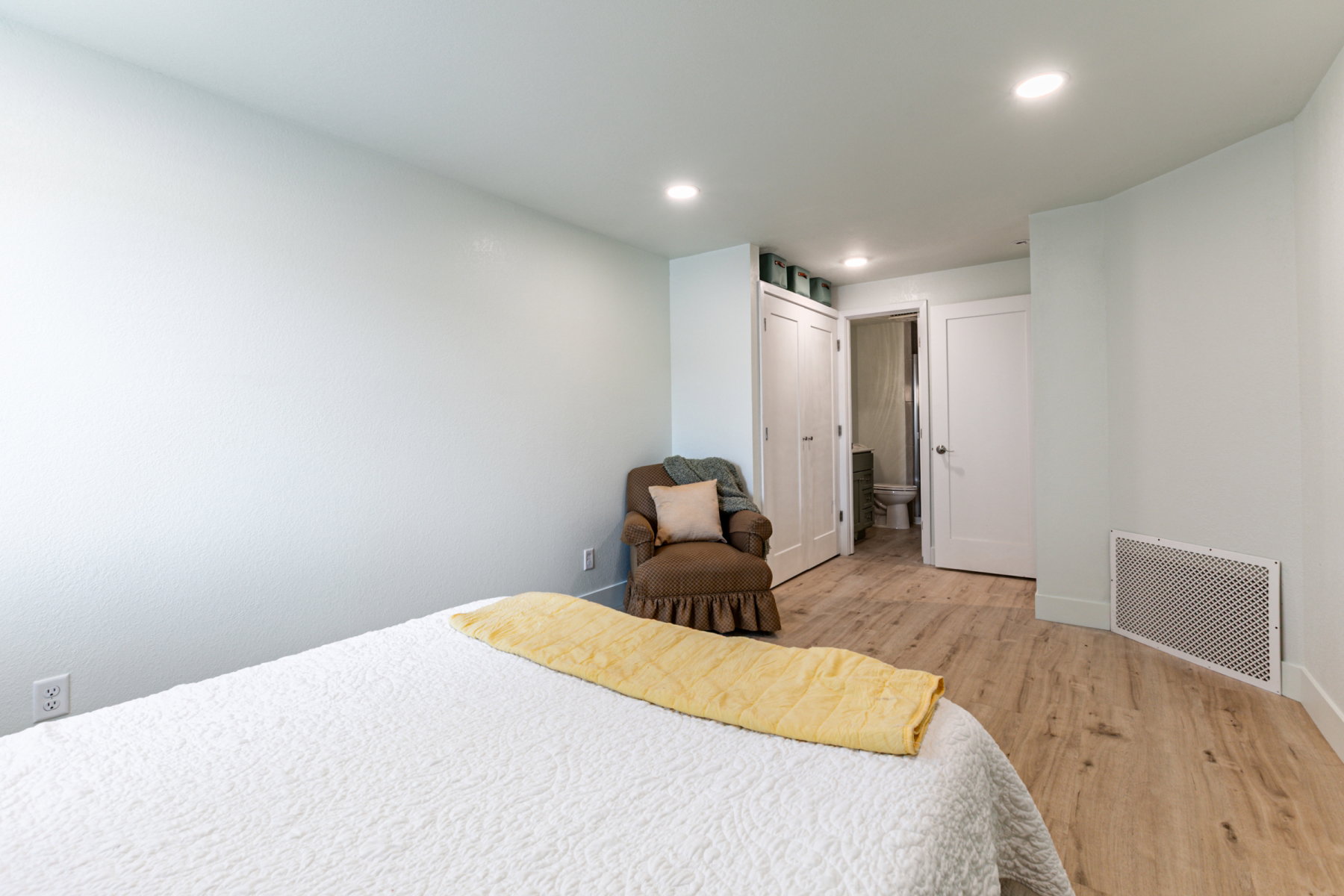 Spacious room featuring light wood-finish flooring, recessed lighting, and a neutral wall color