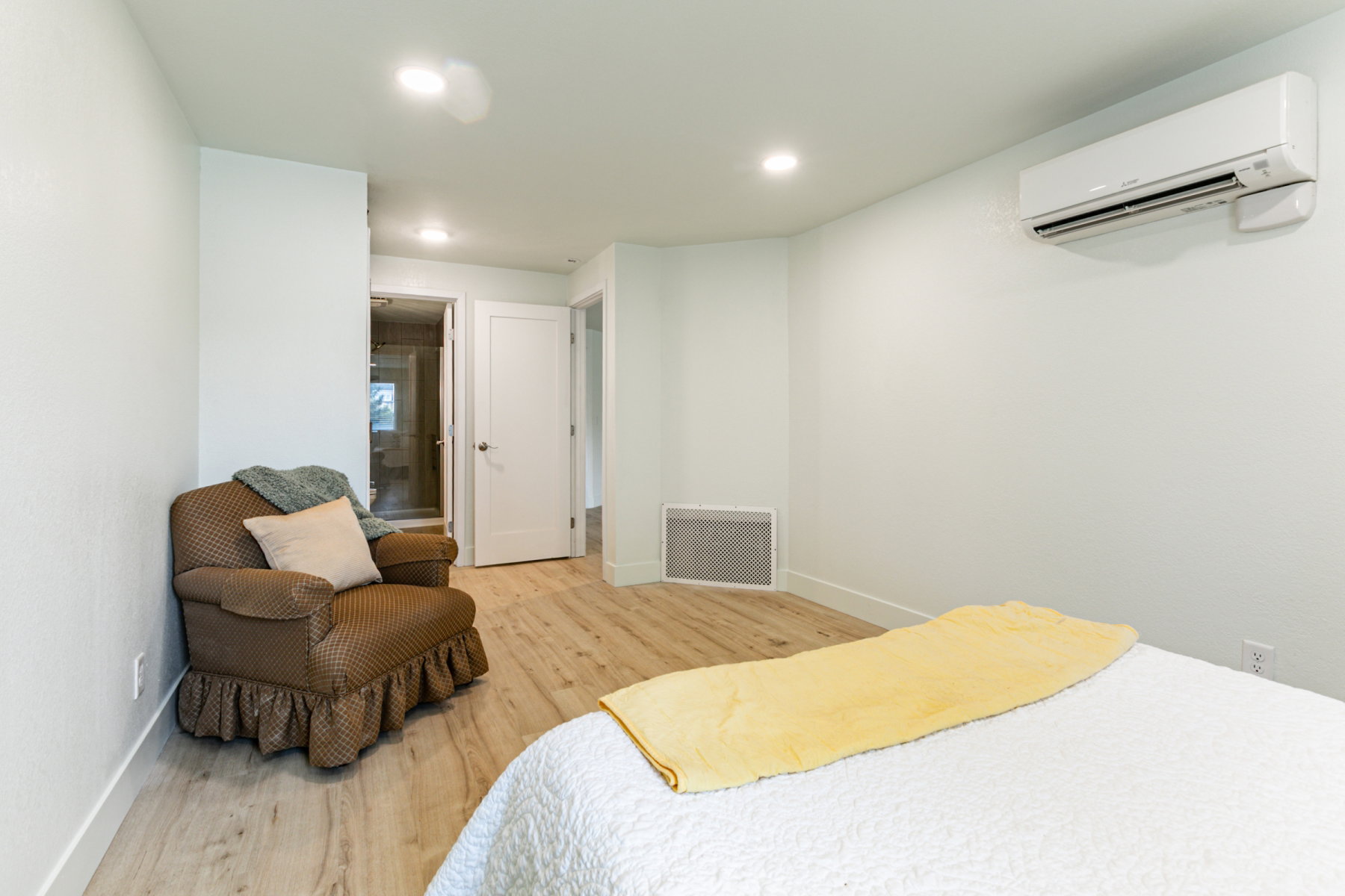 Interior space featuring wood-finish flooring, recessed lighting, and a wall-mounted mini-split HVAC unit