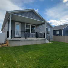 Covered concrete patio with black metal railings