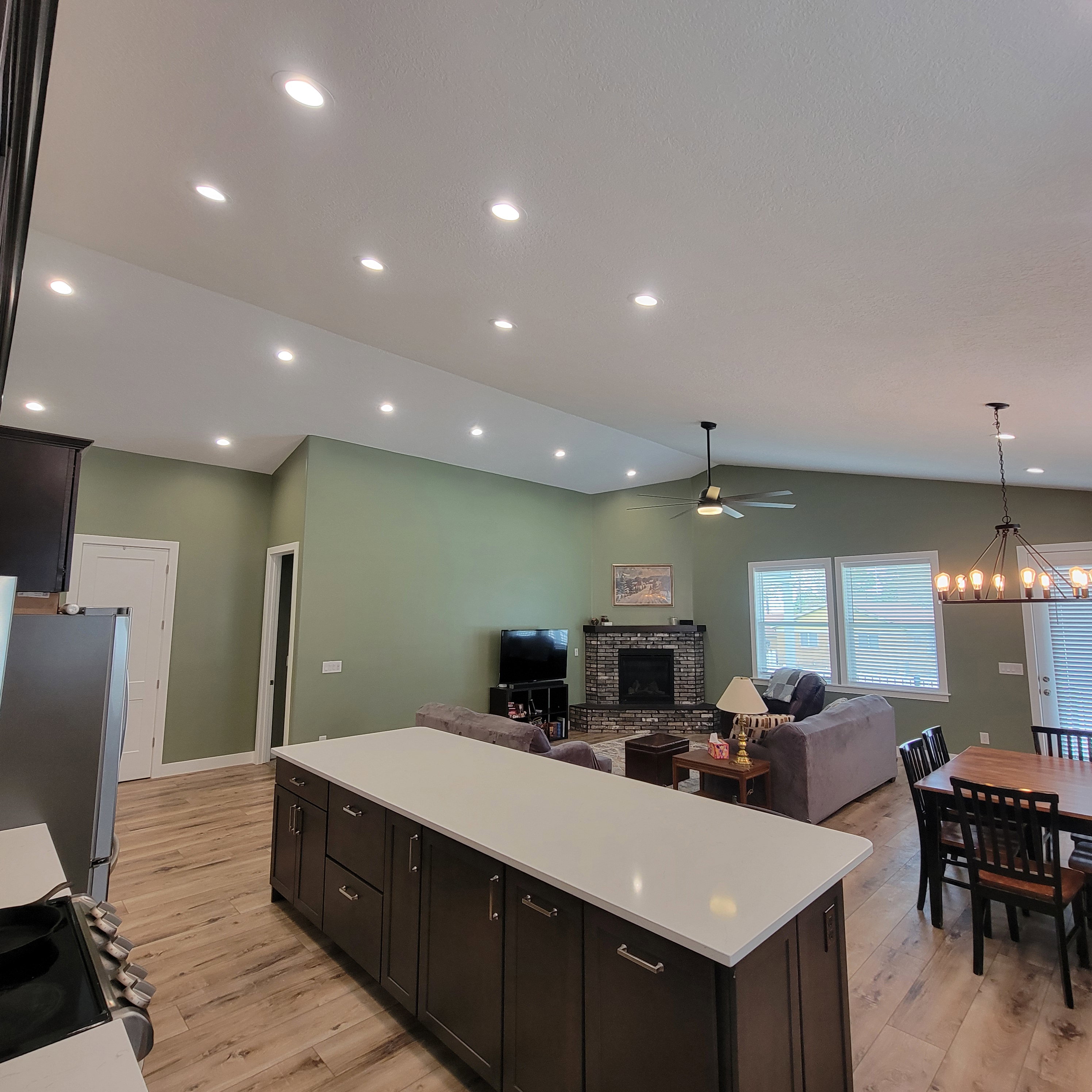 Kitchen island featuring dark wood-finish cabinetry and a light-toned countertop