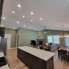 Kitchen island featuring dark wood-finish cabinetry and a light-toned countertop