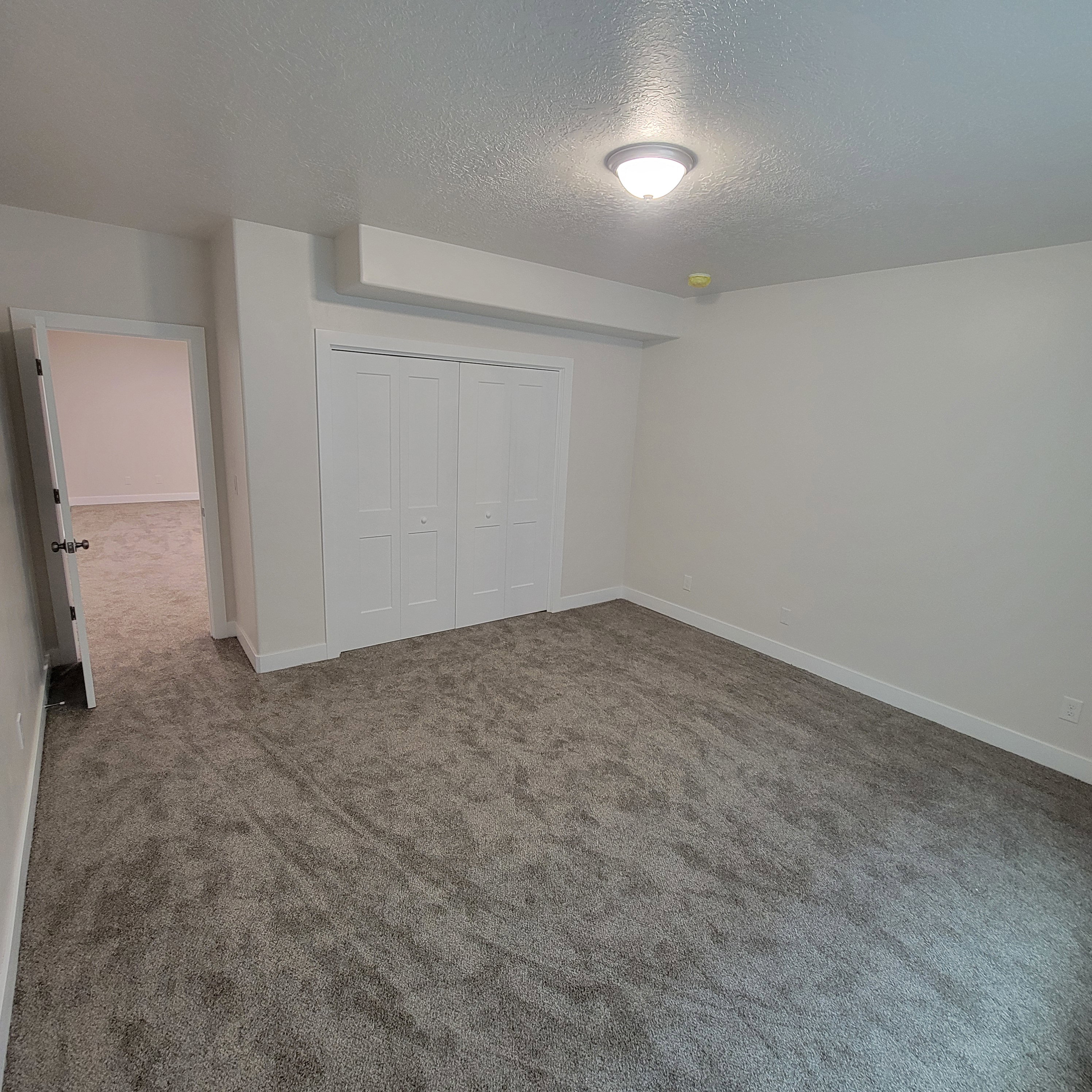 Carpeted interior space featuring white walls and white trim