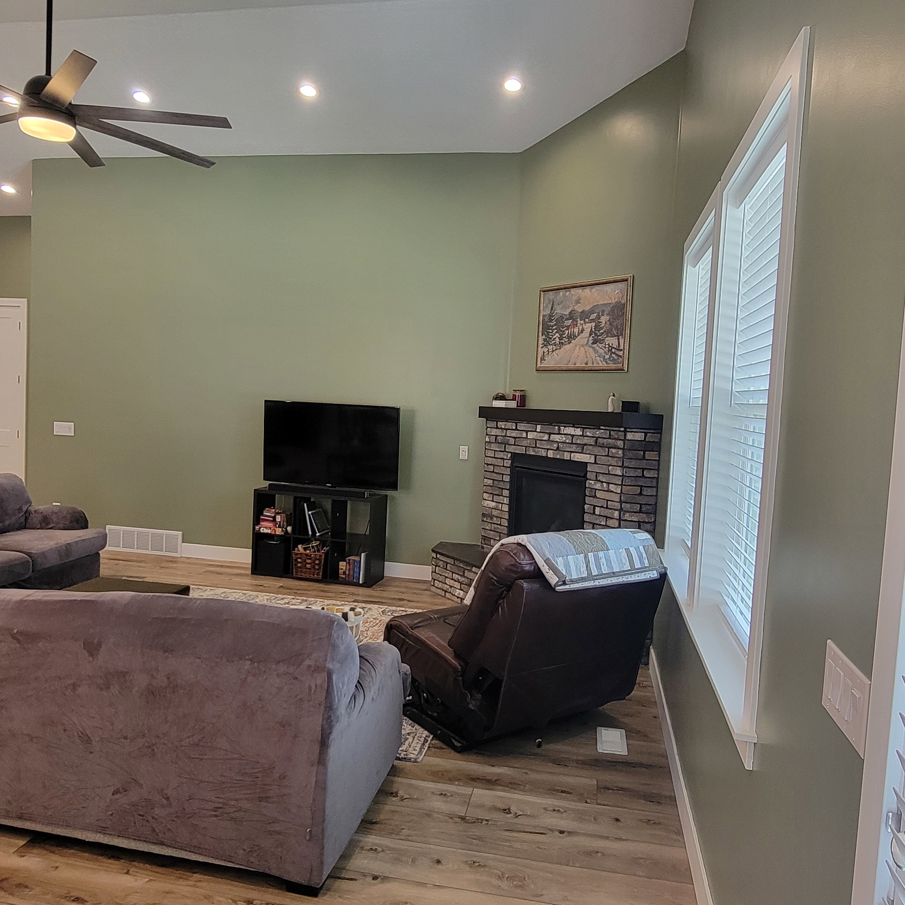 Living area featuring vaulted ceilings, wood-finish flooring, and recessed lighting