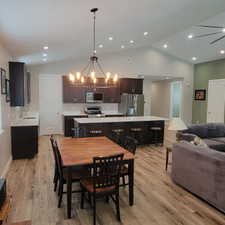 Vaulted ceilings with recessed lighting complement the open-concept design