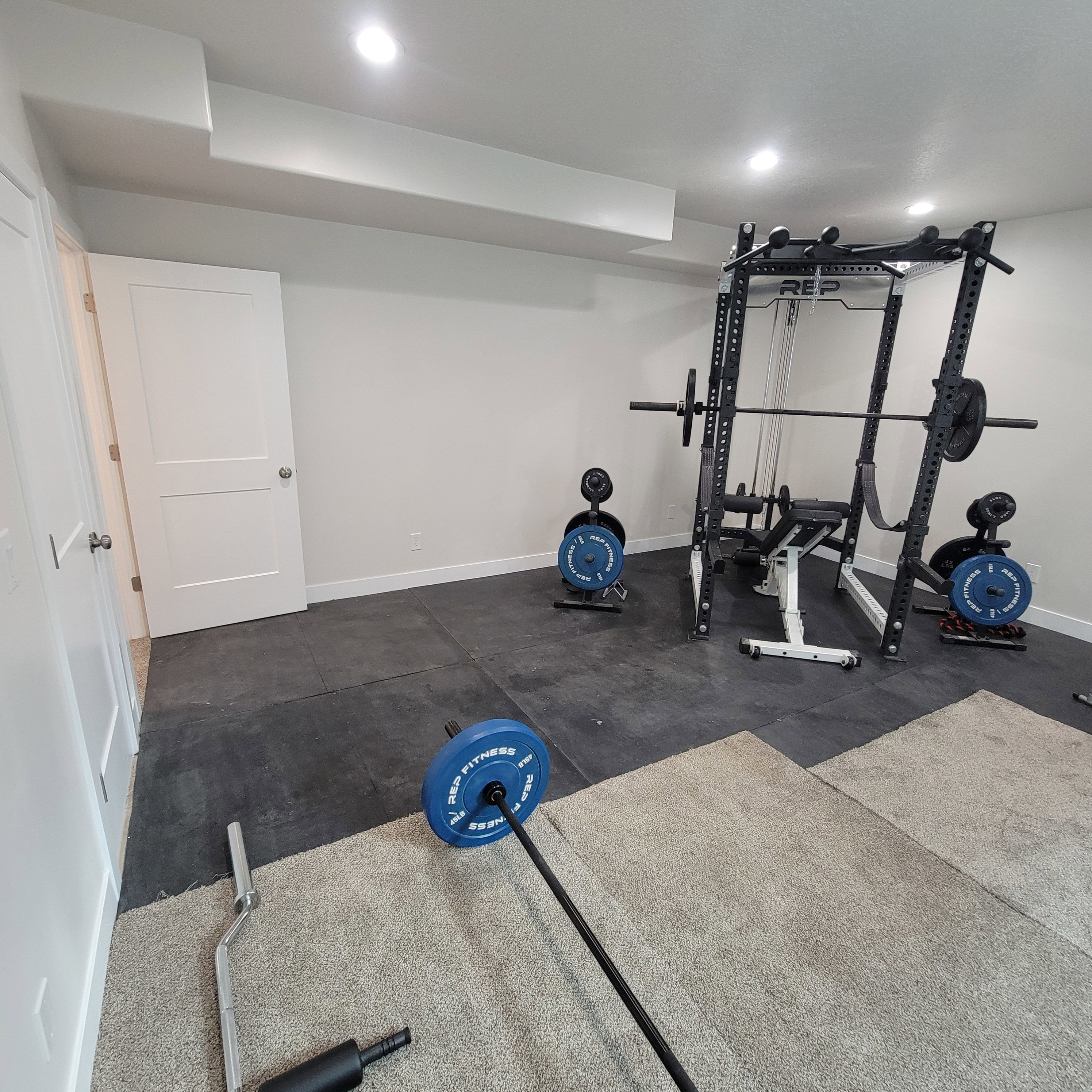 Dedicated room featuring recessed lighting, white walls, and a combination of carpet and rubber mat flooring