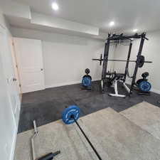 Dedicated room featuring recessed lighting, white walls, and a combination of carpet and rubber mat flooring