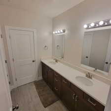 Double vanity featuring white countertops, undermount sinks, and brushed nickel fixtures