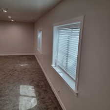 Carpeted interior space featuring light-colored walls and white trim