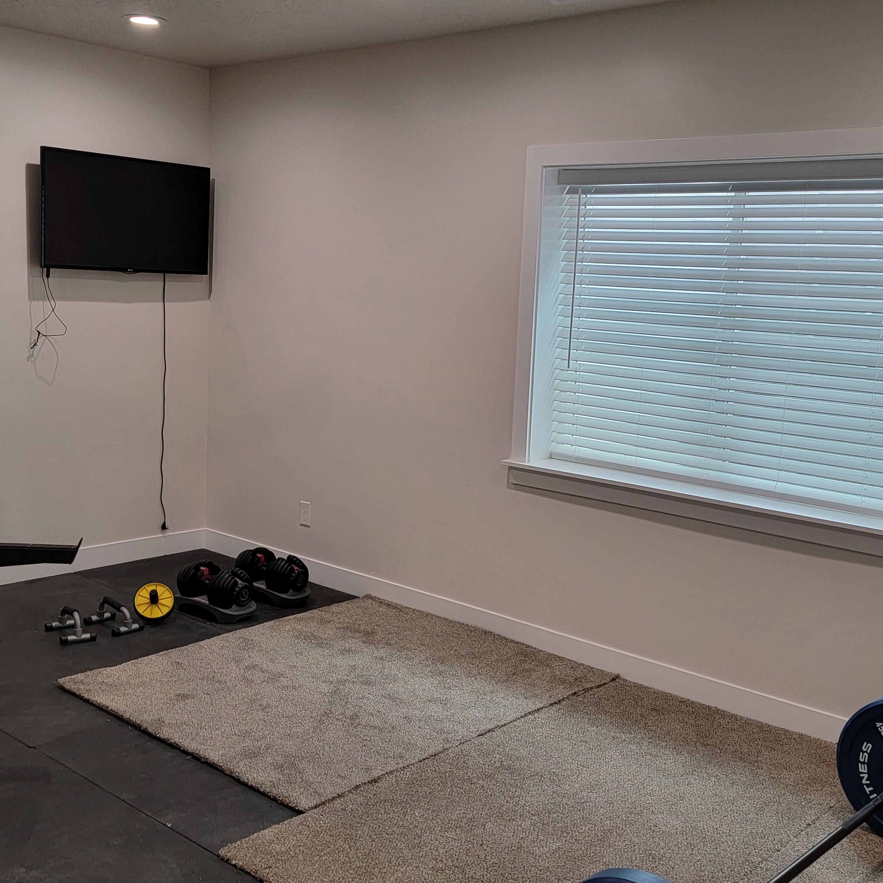 Recessed lighting, neutral wall tones, and baseboard trim