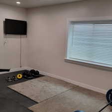 Recessed lighting, neutral wall tones, and baseboard trim