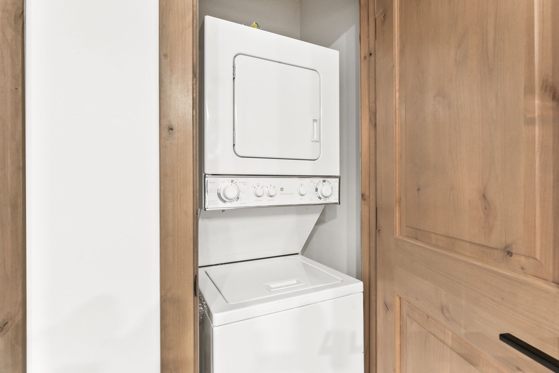 White stacked washer and dryer unit