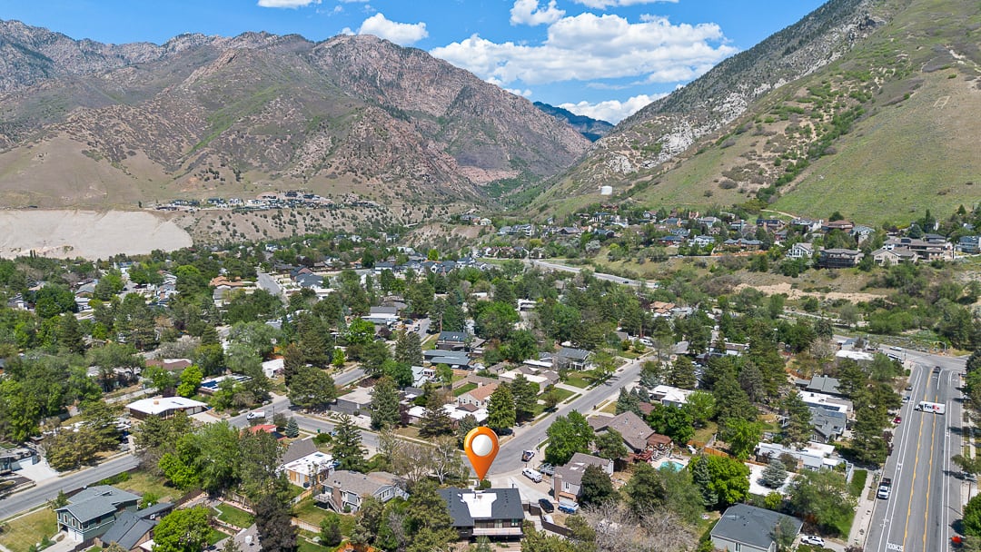 Aerial perspective showcasing a residential area amidst mountainous terrain