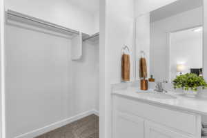 Integrated vanity with a single basin sink, chrome faucet, and expansive wall mirror