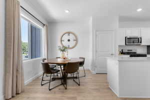 Dining area featuring wood-finish flooring and a large window