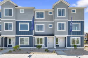 Contemporary multi-level exterior featuring light blue and dark blue siding accents