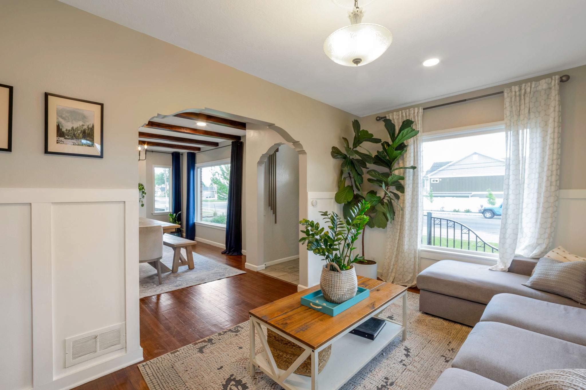 Living area featuring a large window, recessed lighting, and wood-finish flooring