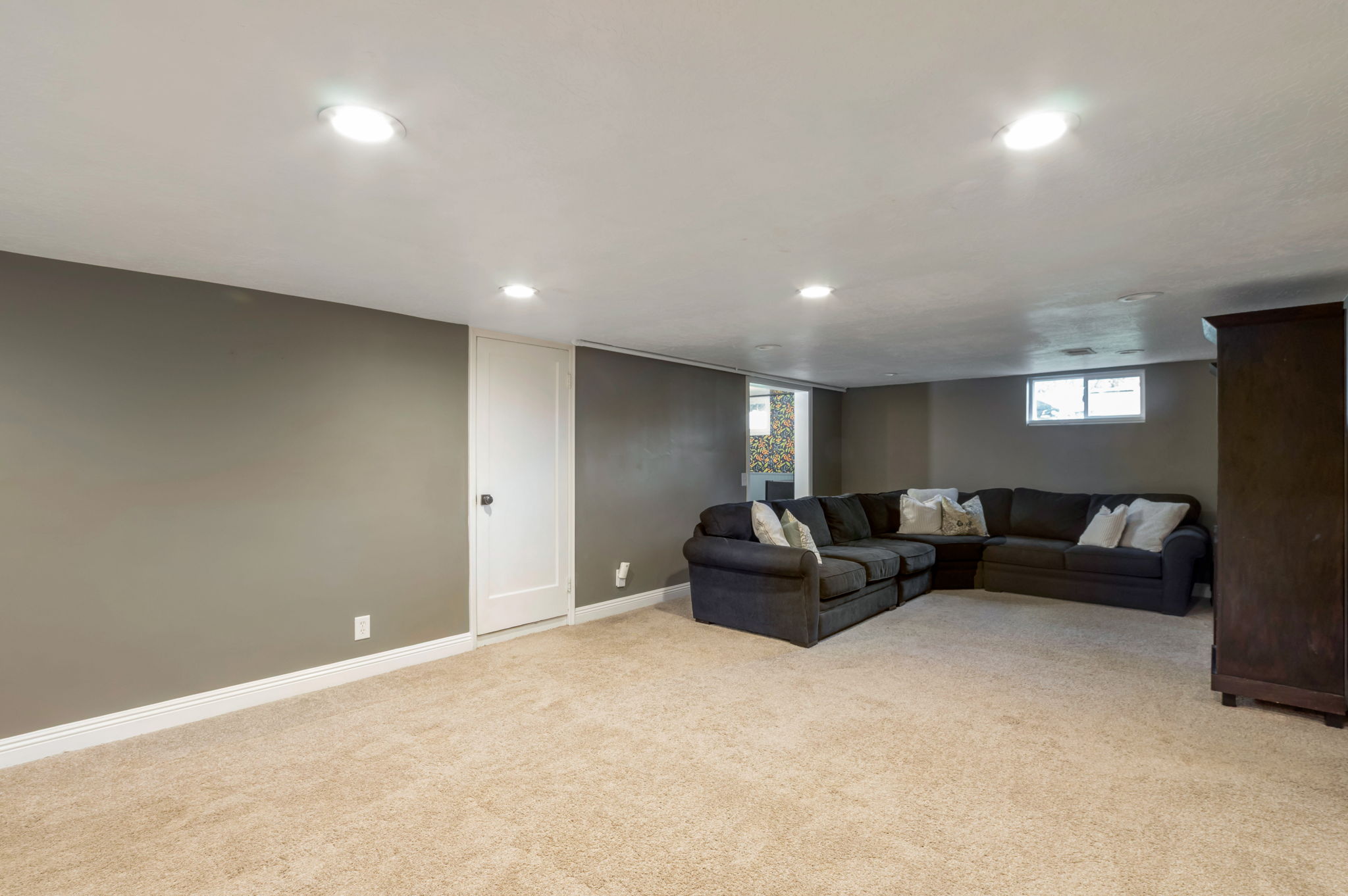 Spacious lower level featuring plush carpeting, recessed lighting, and neutral wall tones