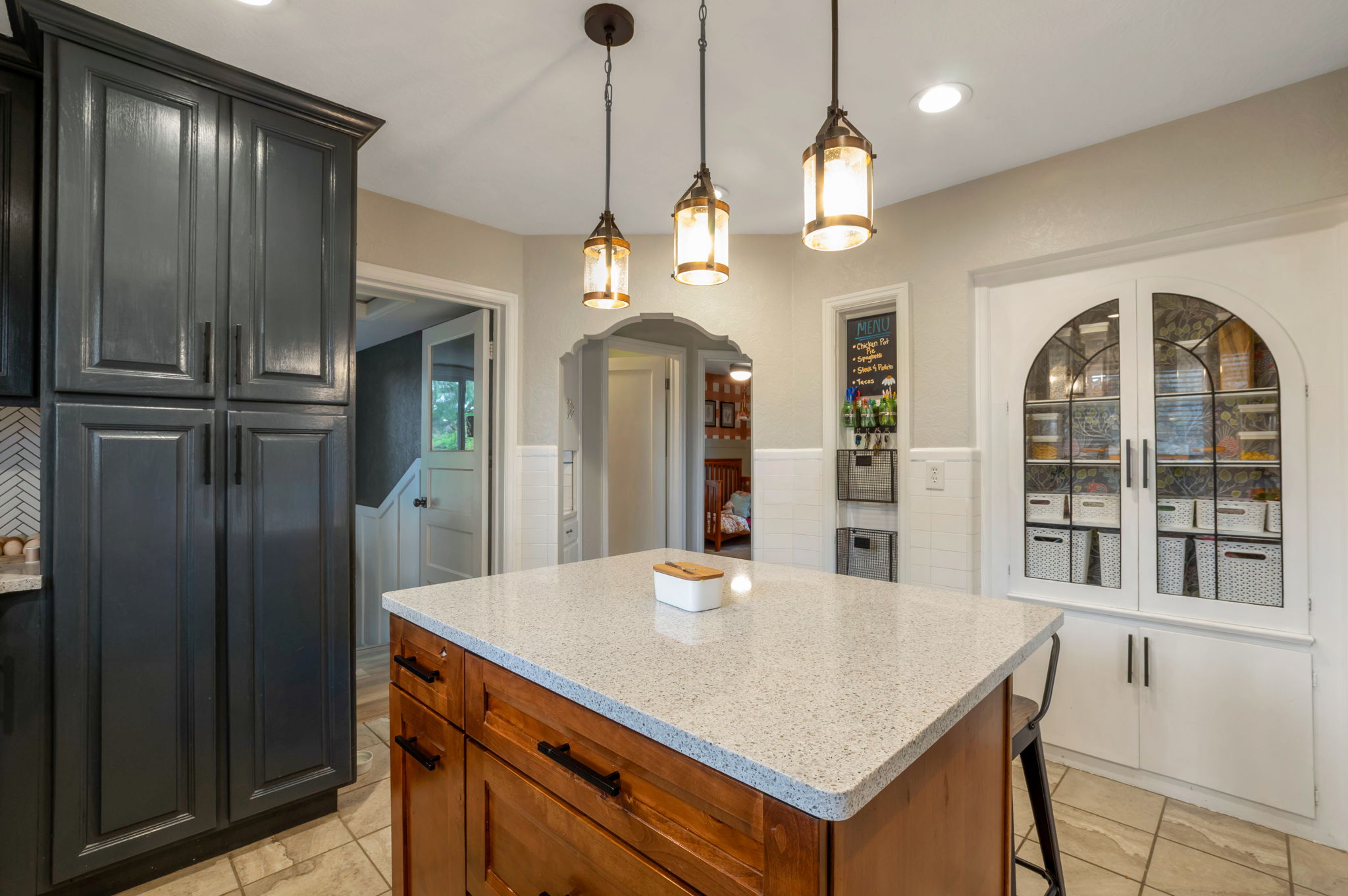 Kitchen island with a light-toned countertop and wood-finish cabinetry