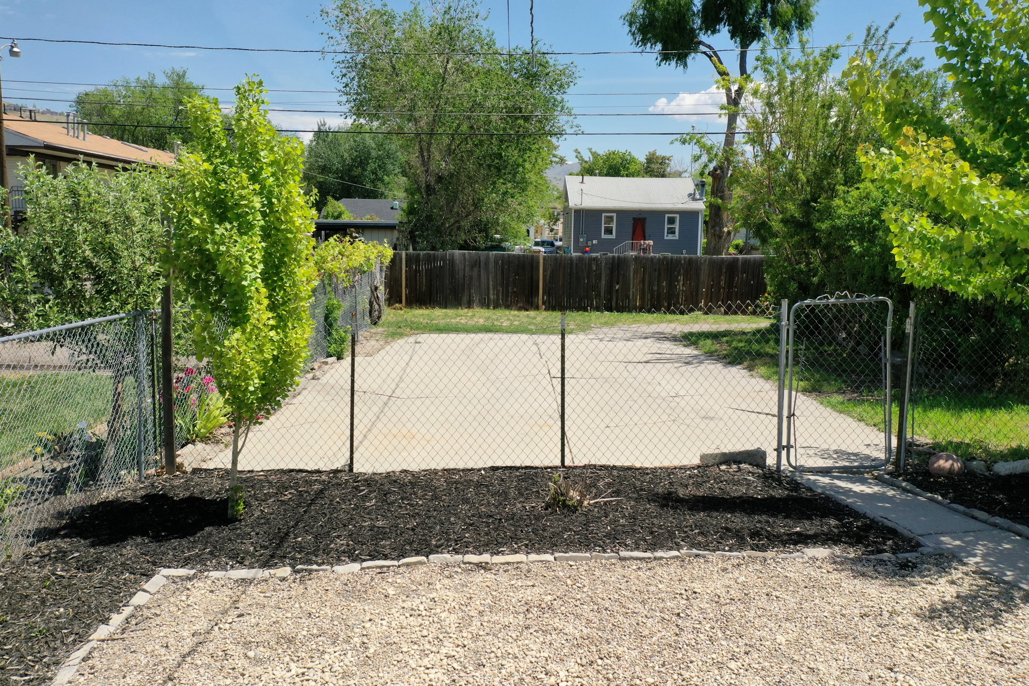 Paved driveway with a chain-link fence and gate