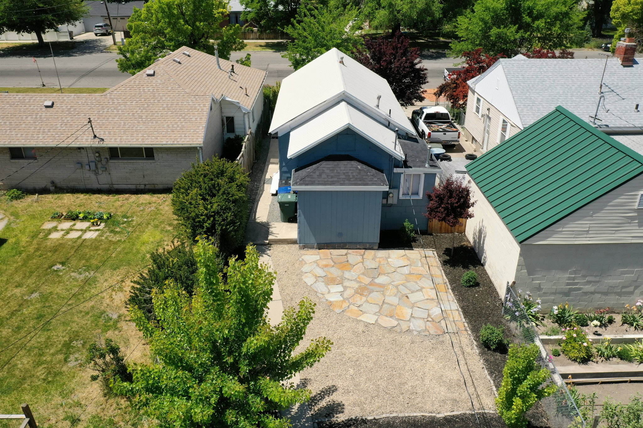 Property exterior featuring a light blue facade and a prominent white metal roof