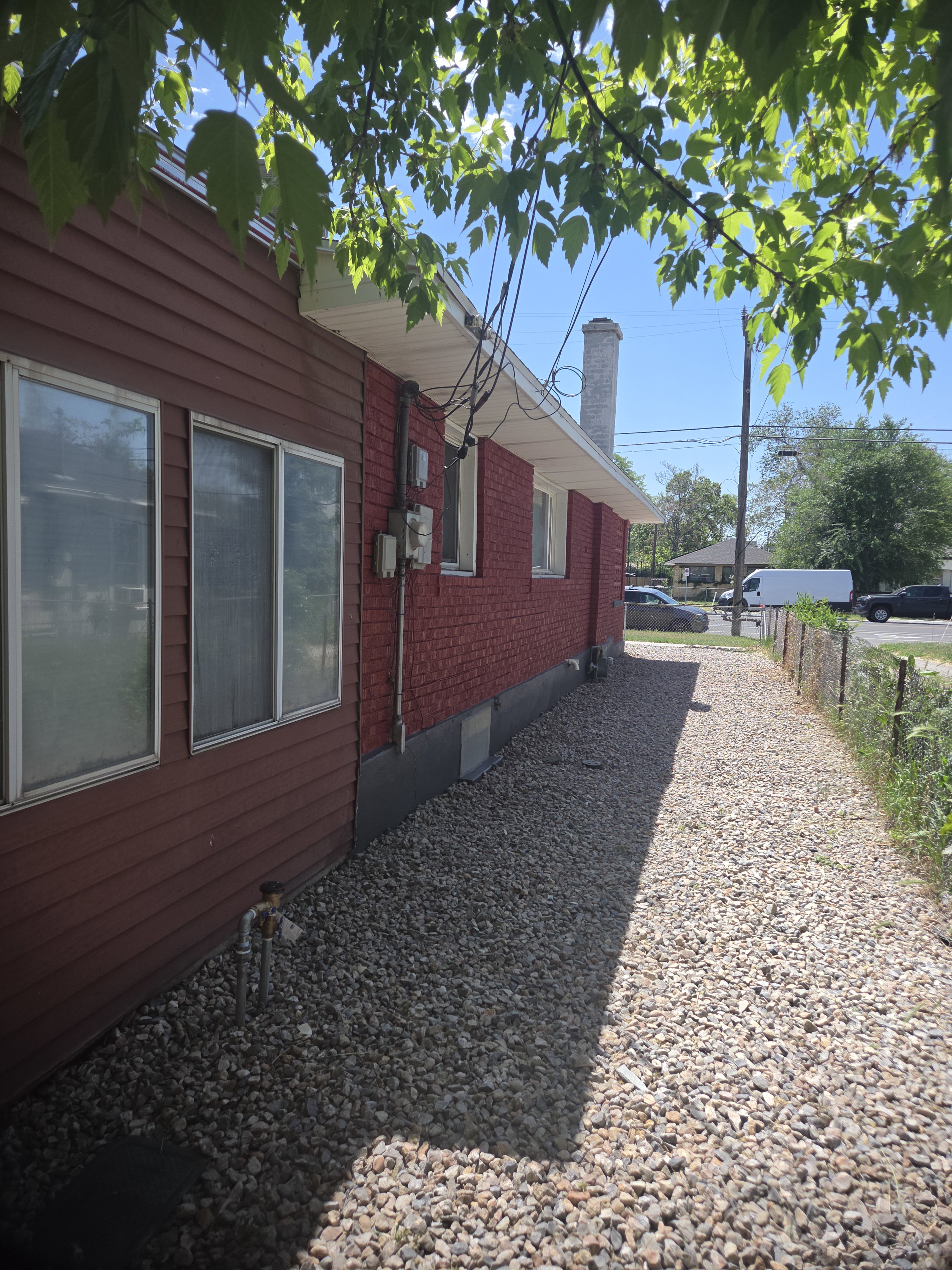 Exterior siding with red brick accents and white soffit