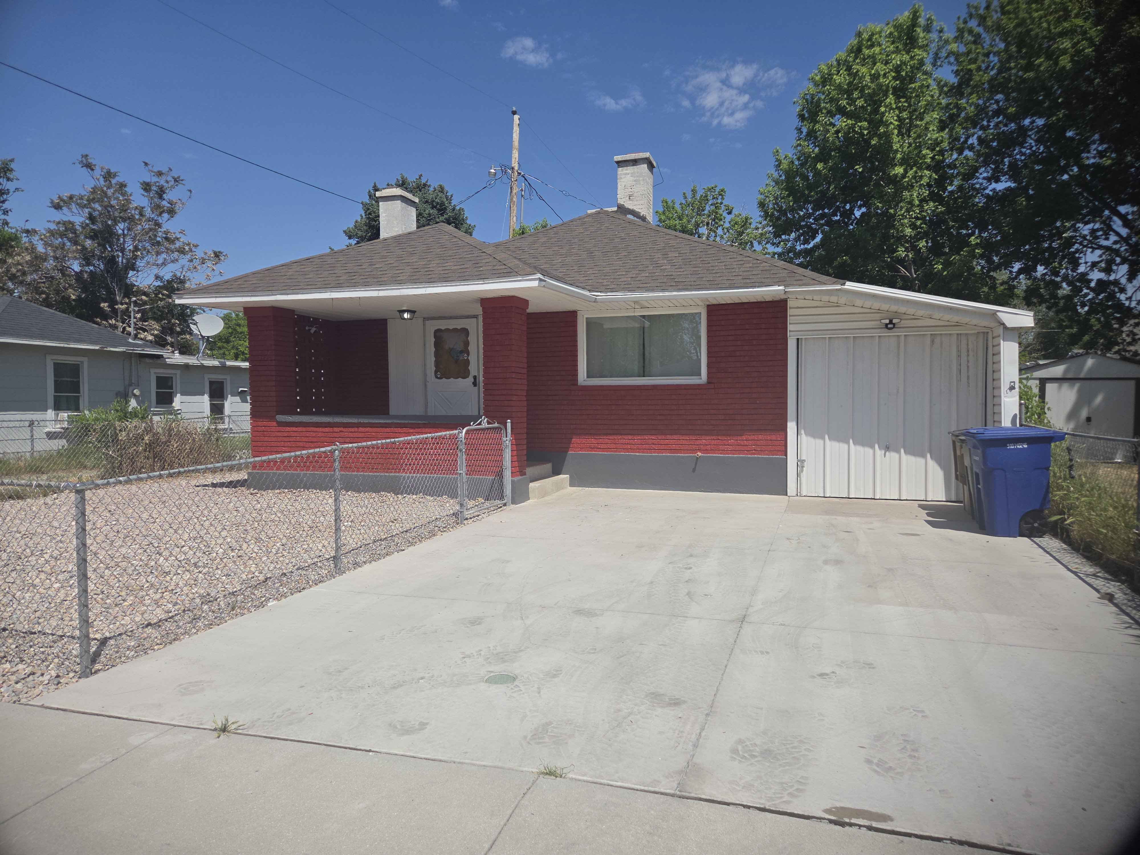 Red brick exterior with a covered front porch and concrete driveway