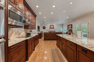 Gourmet kitchen with mahogany wood cabinetry, granite countertops, stainless steel appliances, Thermador double oven