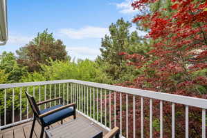 Private balcony off master bedroom featuring Trex flooring and white baluster railing