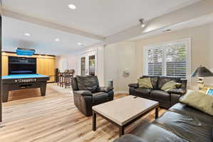Spacious lounge area featuring wood-finish flooring with separate surround sound