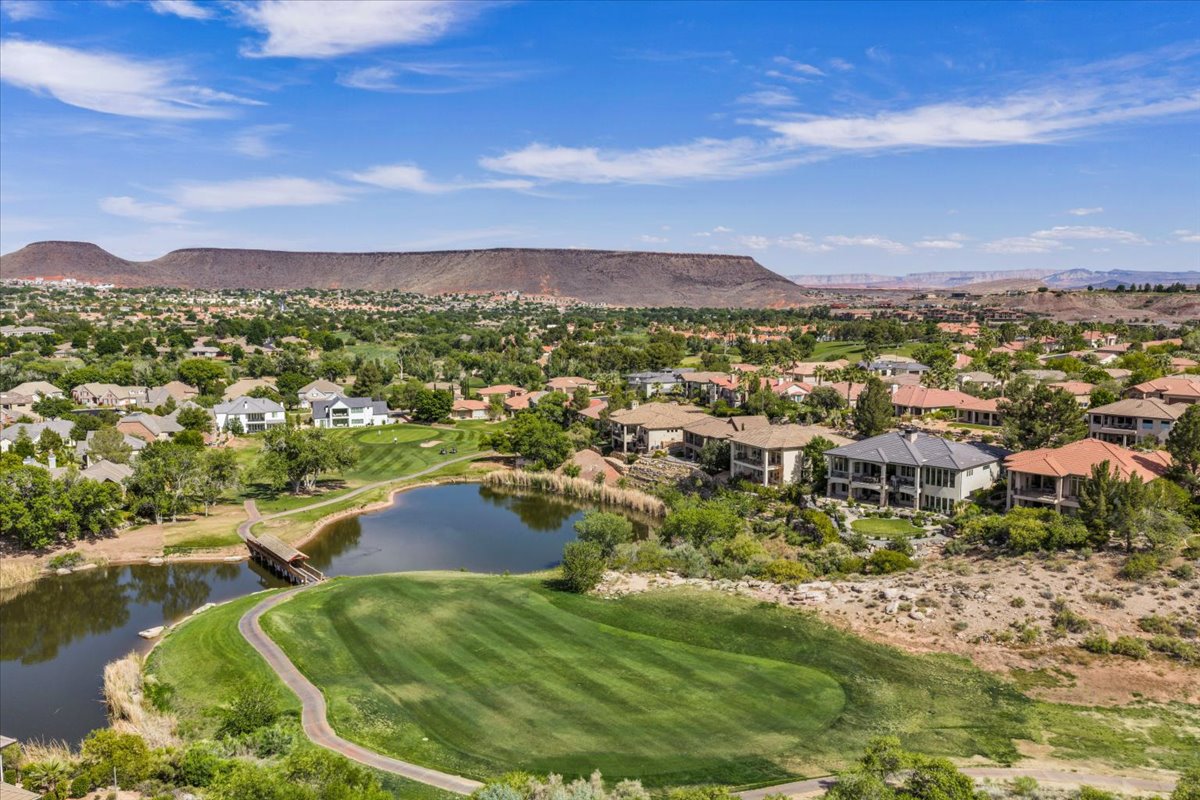 Aerial perspective showcasing Sunbrook Communities with a golf course, natural water features, and expansive mountain scenery