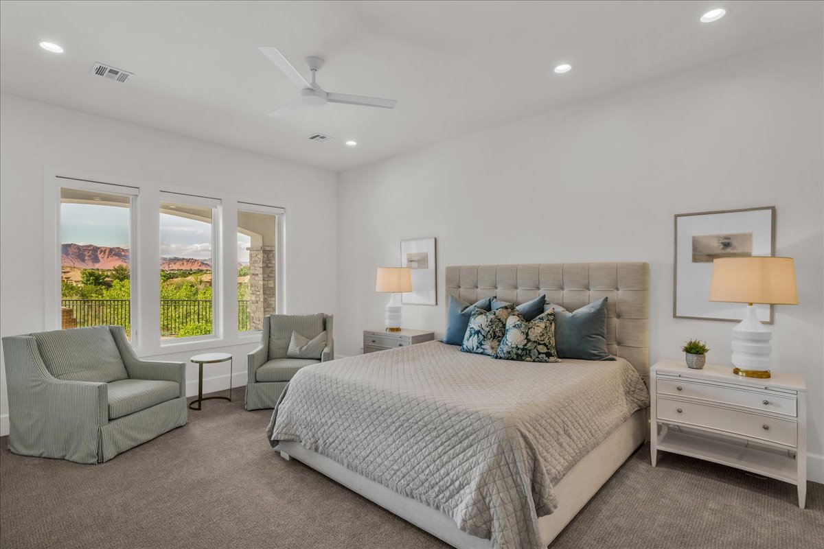 Spacious room featuring white walls and grey carpet flooring