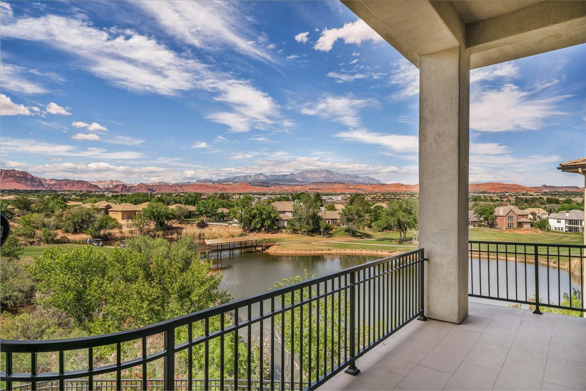 Expansive outdoor patio featuring tile flooring and a black metal railing