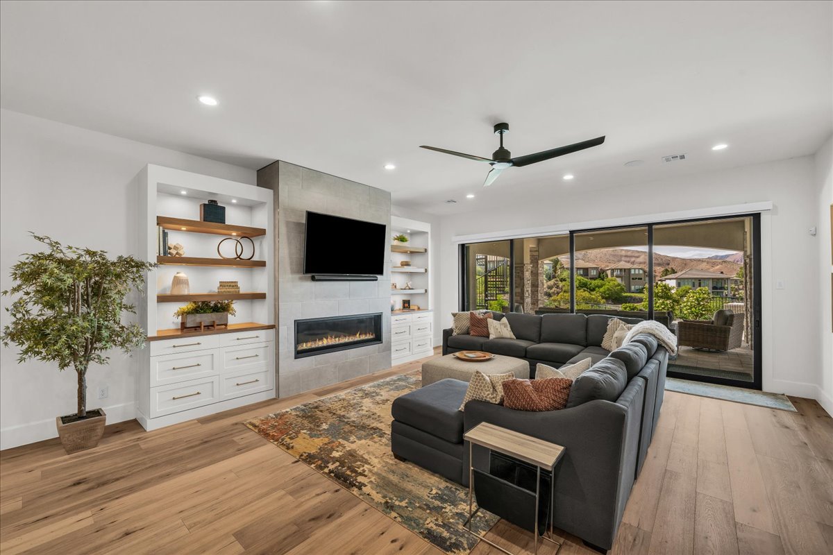 Spacious living area featuring light wood-finish flooring and recessed lighting