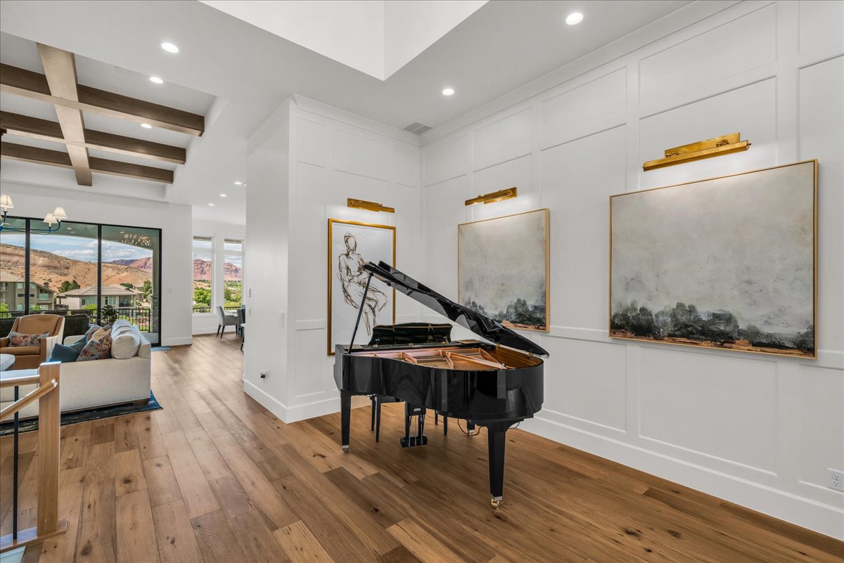 Hardwood flooring throughout featuring recessed lighting and a beamed ceiling