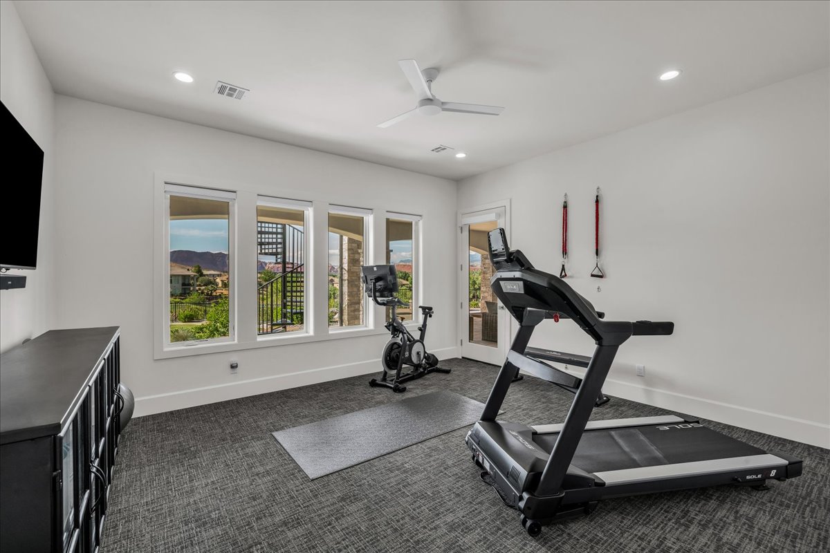 Bright interior space featuring recessed lighting, a ceiling fan, and carpeted flooring