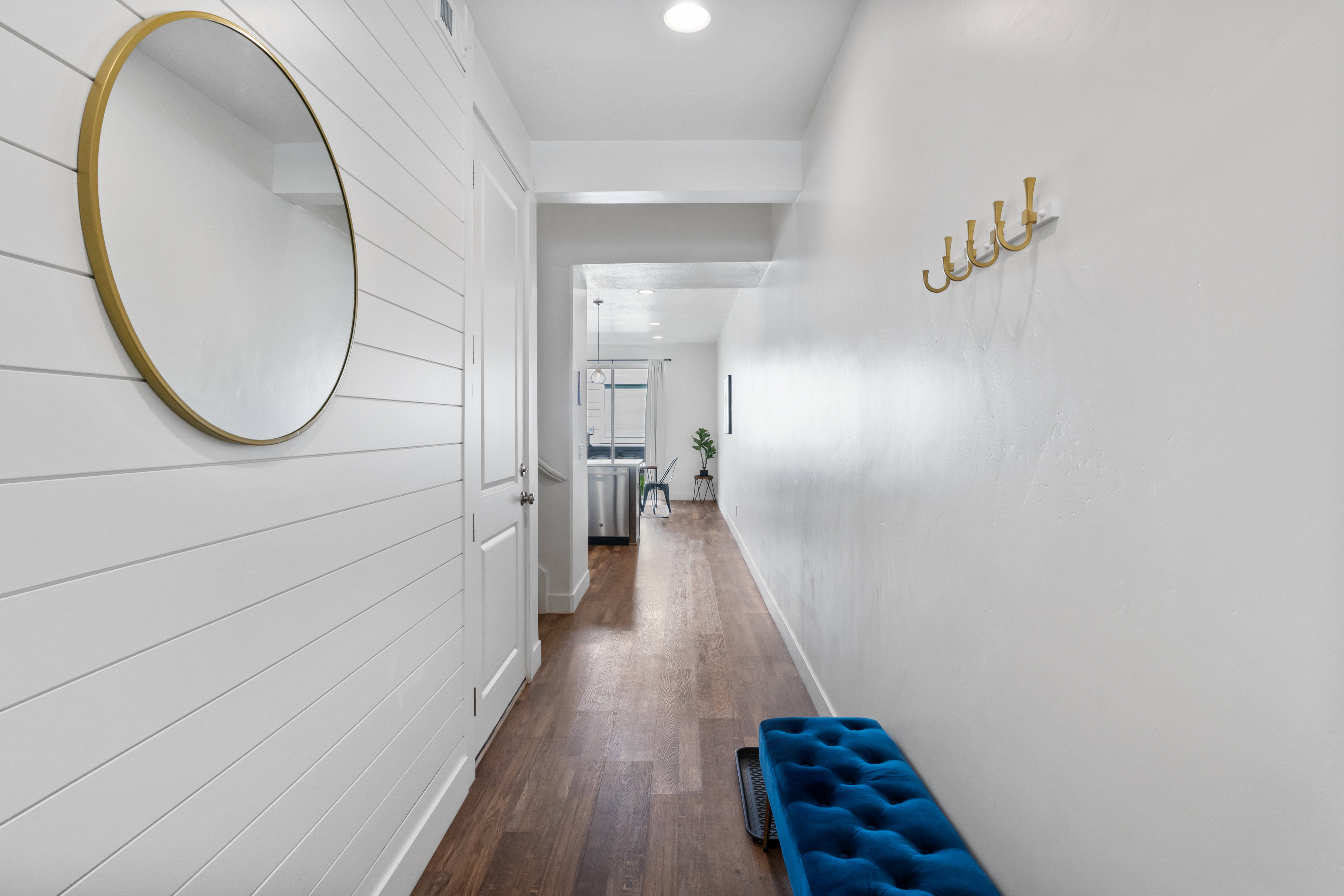 Entryway featuring wood-finish flooring and shiplap accent wall